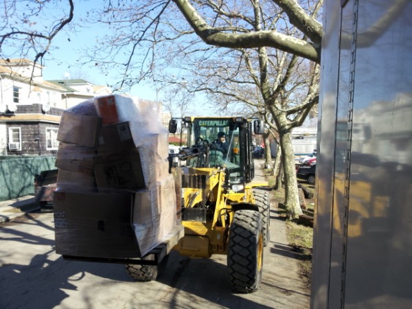New York City Sanitation Department helping unload pallets off the trailer. 