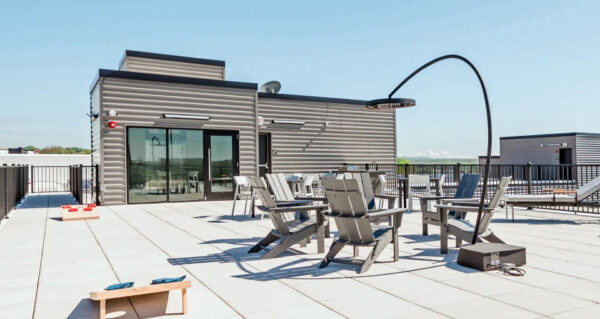 Rooftop patio at Industrie Apartments in Albany, NY featuring comfortable seating and sustainable electric heating.